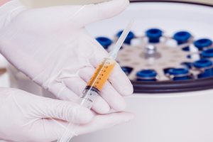 Medical provider preparing a PRP injection for a patient receiving regenerative treatment for joint pain at Regenerate Richmond.